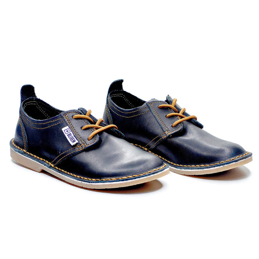 Pair of black leather shoes with copper gold laces on a white background