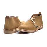 Pair of tan suede boots on a white background