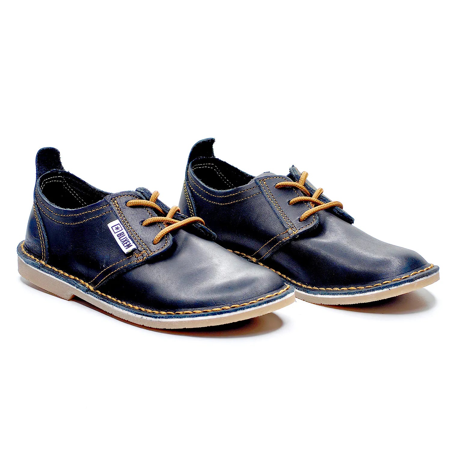 Pair of black leather shoes with copper gold laces on a white background