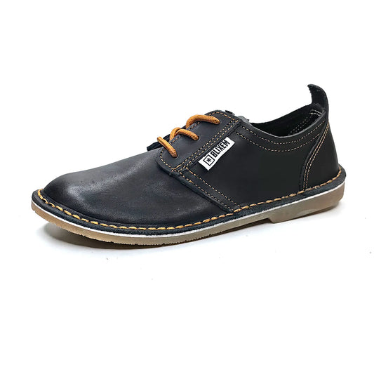 Black leather shoe with copper gold laces on a white background