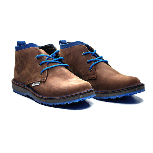 Brown boots with blue laces and soles on a white background