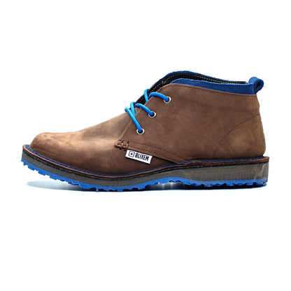Brown leather boot with blue laces and sole on a white background
