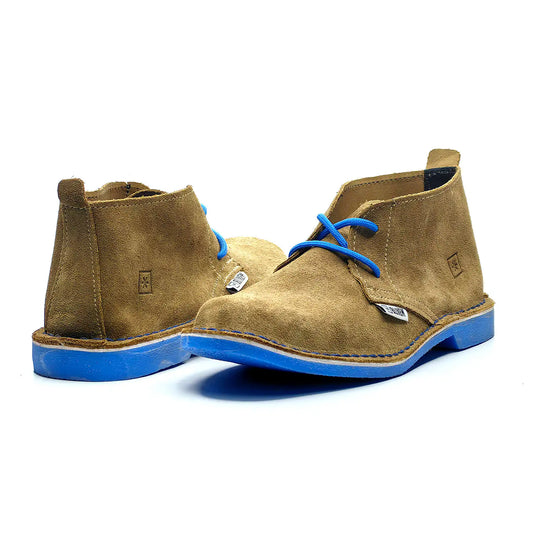Pair of brown suede boots with blue soles on a white background