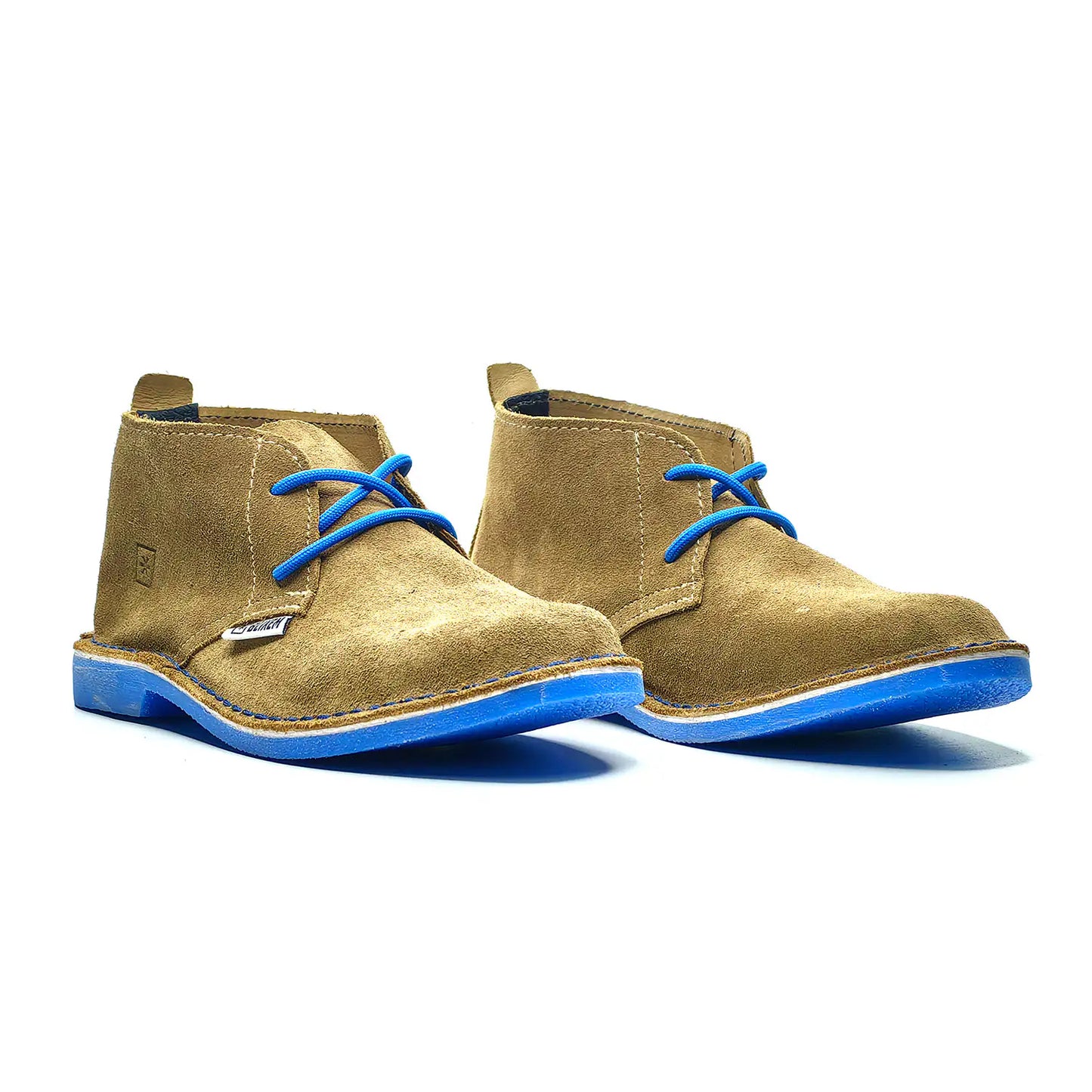 Pair of tan boots with blue soles on a white background