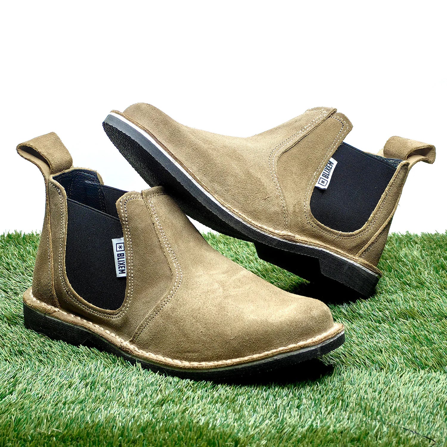 Pair of brown suede shoes on a grass background