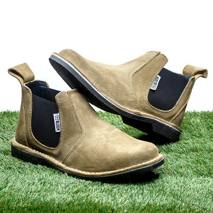 Pair of brown suede shoes on a grass background