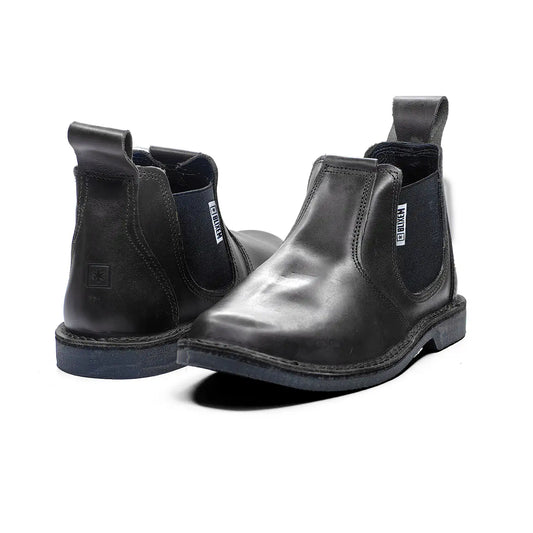 Pair of black leather Chelsea boots on a white background