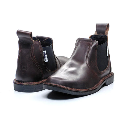 Pair of brown leather Chelsea boots on a white background