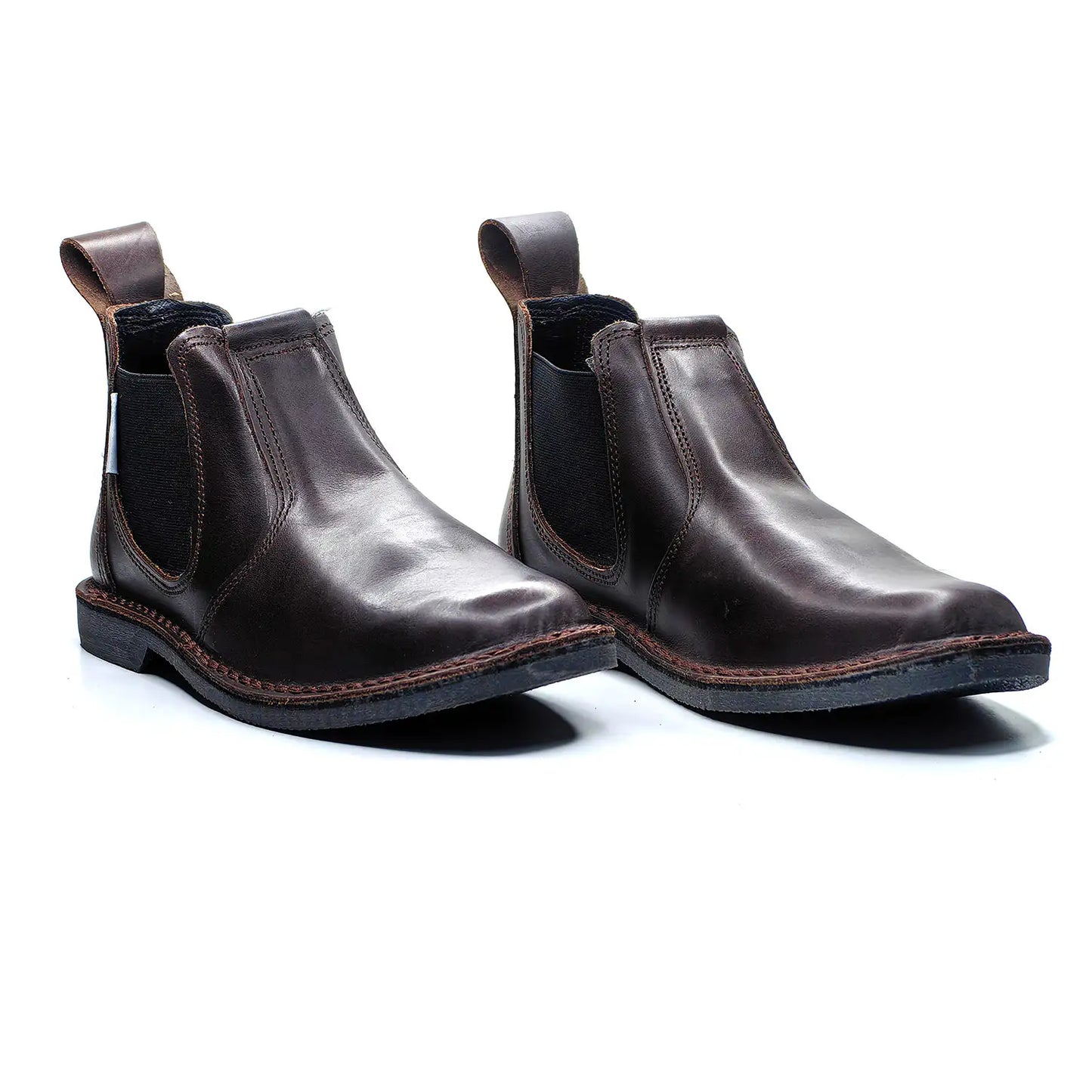 Pair of brown leather Chelsea boots on a white background