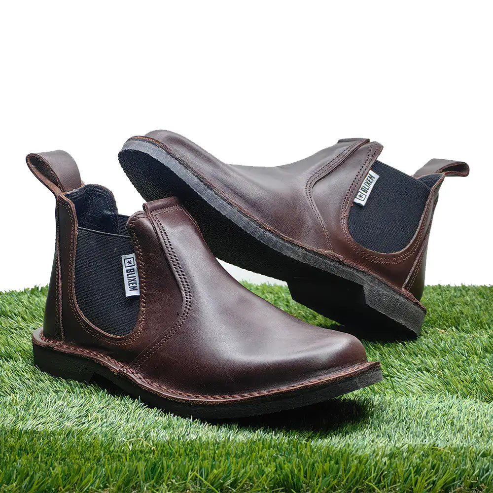 Brown leather boots on a grassy surface