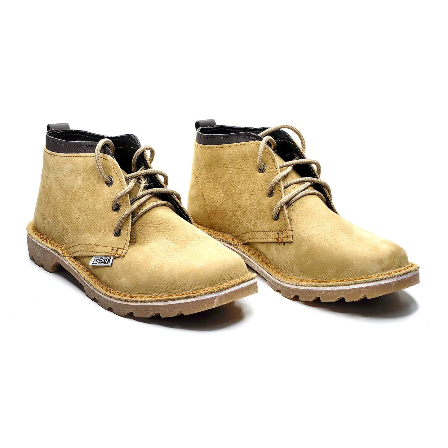 Pair of tan boots with black laces on a white background