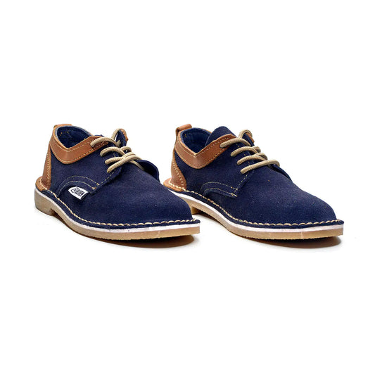 Pair of blue suede shoes with brown accents on a white background