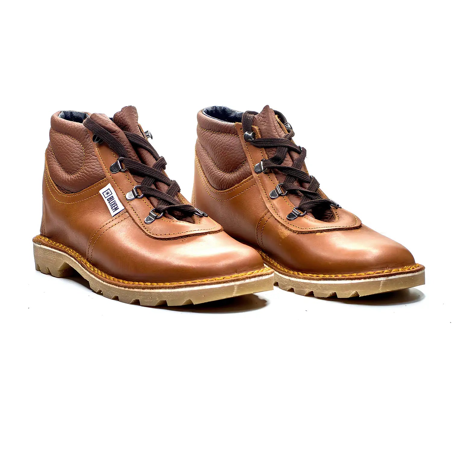 Pair of red tan leather boots on a white background