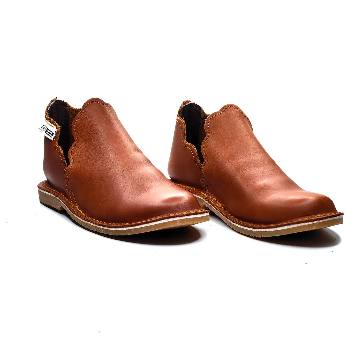 Pair of brown leather boots on a white background