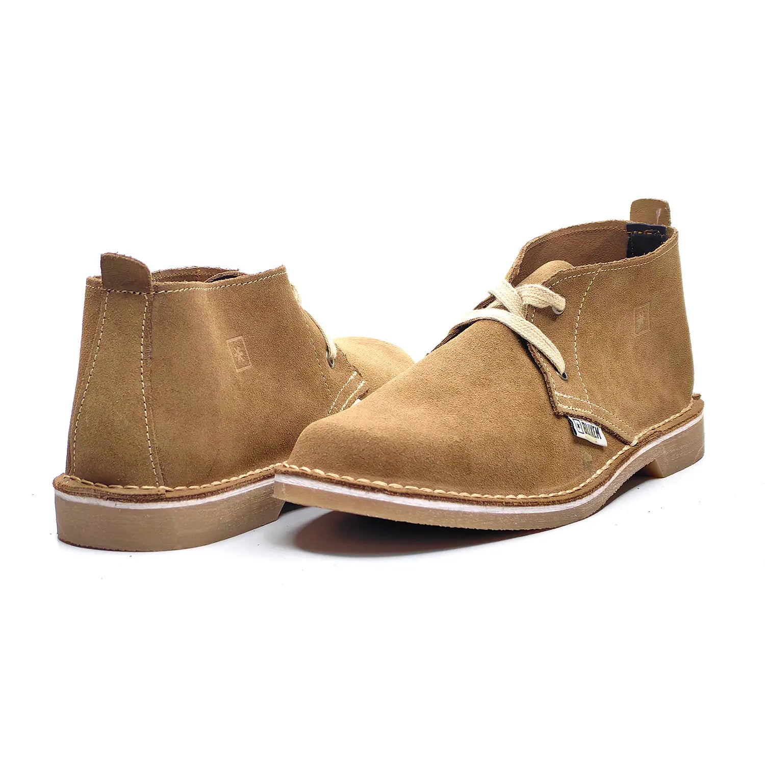 Pair of tan suede boots on a white background