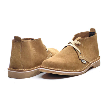 Pair of tan suede boots on a white background
