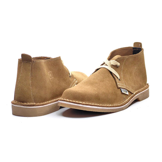 Pair of tan suede boots on a white background