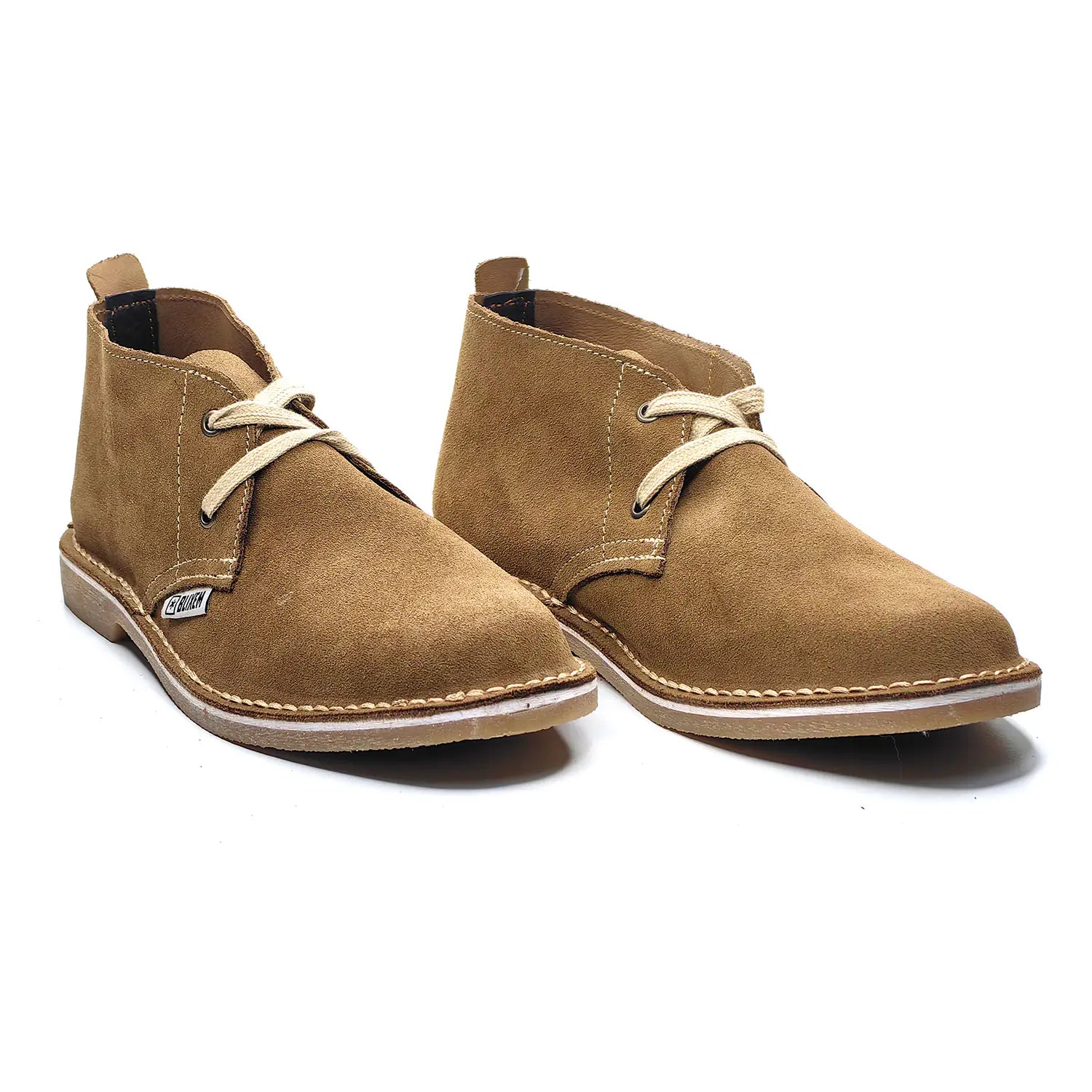 Pair of tan suede boots with white laces on a white background