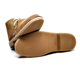 Brown leather shoes with white soles on a white background